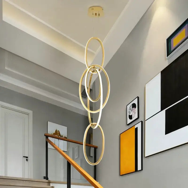 Modern gold steel pendant light with interconnected circular rings for dining room decorbites gold steel pendant light