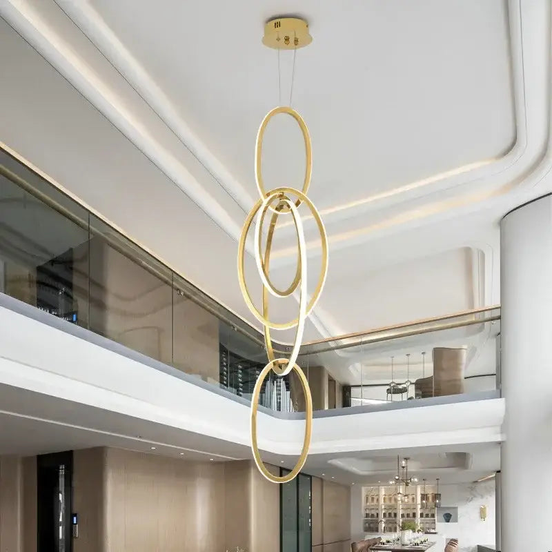 Modern gold steel pendant light with interlocking circular rings for dining room decorbites gold steel pendant
