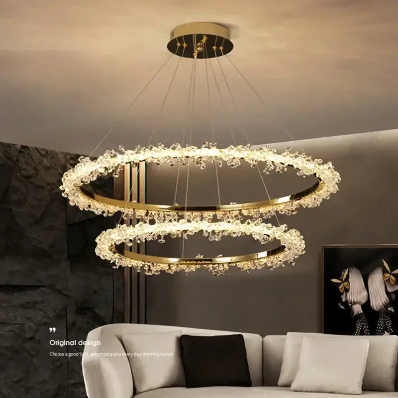 Modern gold swirling crystal pendant chandelier featuring gold-toned double rings with sparkling decorbites crystal accents