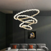Modern gold swirling crystal pendant chandelier with clear crystal accents by decorbites for elegant dining room decor
