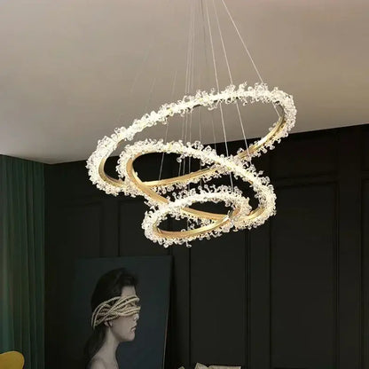 Modern gold swirling crystal pendant chandelier featuring multiple interlocking rings with clear crystals decorbites crystal pendant