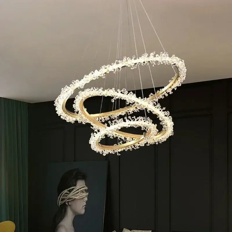 Modern gold swirling crystal pendant chandelier featuring multiple interlocking rings with clear crystals decorbites crystal pendant