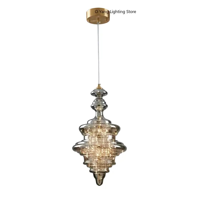 Modern gold tiered pendant light with crystal detailing and clear acrylic rods for elegant dining room modern interiors