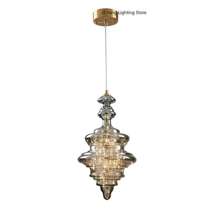 Modern gold tiered pendant light with crystal detailing and clear acrylic rods for elegant dining room modern interiors