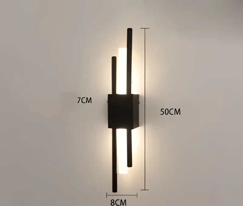 Modern black wall sconce with three vertical led bars emitting warm light for decorbites gold tube wall lighting