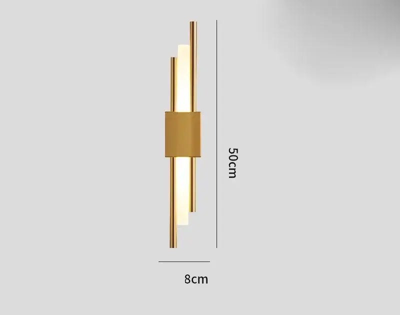 Modern gold tube wall sconce with fabric diffuser featuring three vertical illuminated bars and a central rectangular accent
