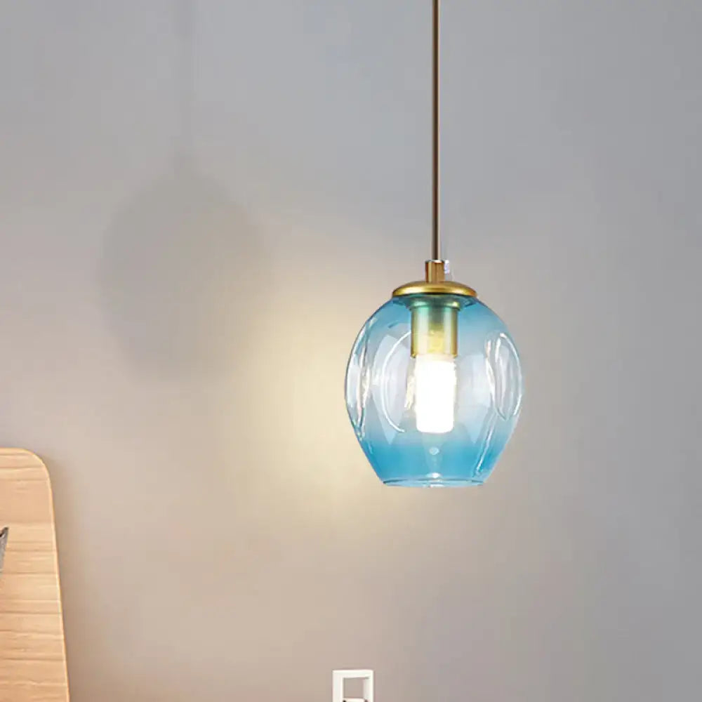 Modern gold tulip wall lamp with a translucent blue glass shade and brass-finished fixture for bedroom use