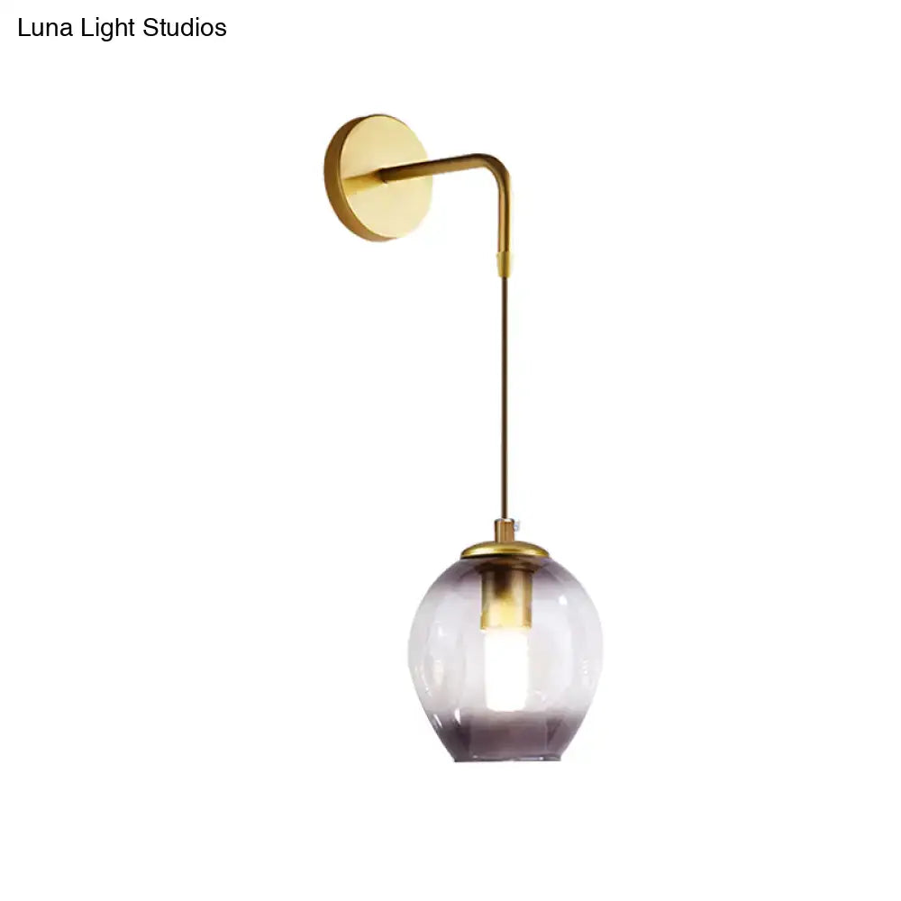Modern gold tulip wall lamp with brass arm and purple glass shade for bedroom as a stylish wall lamp feature