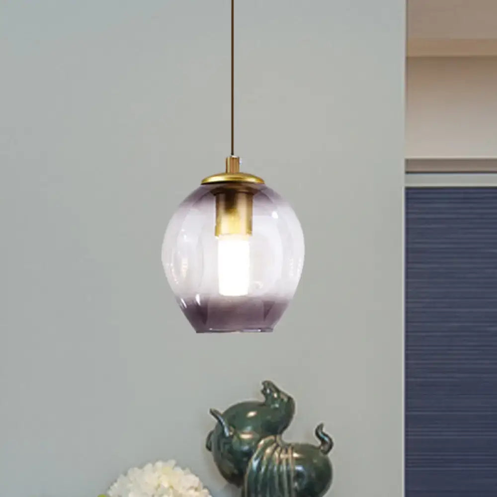 Modern gold tulip wall lamp with a blue glass shade and brass accents featuring a gradient purple pendant light globe