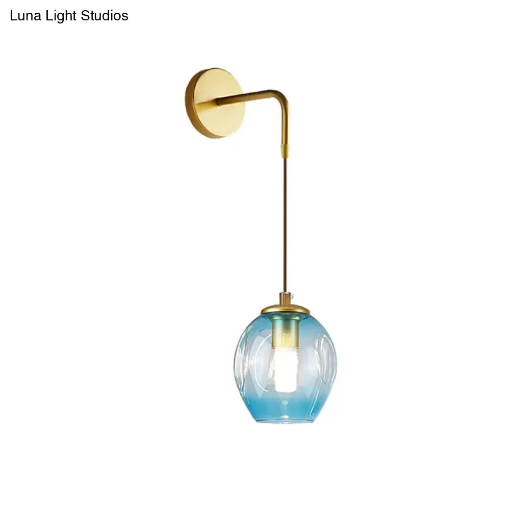 Modern gold tulip wall lamp with a sleek brass curved arm and gradient blue glass shade for bedroom lighting