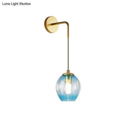 Modern gold tulip wall lamp with a sleek brass curved arm and gradient blue glass shade for bedroom lighting