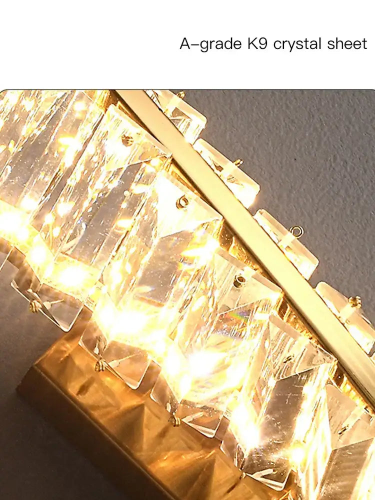 Modern gold twisted crystal wall sconce featuring a-grade k9 crystal sheets with warm golden lighting decorbites crystal wall