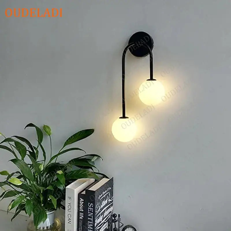 Black metal wall lamp with two glowing decorbites glass ball led shades for modern living room sconce lighting