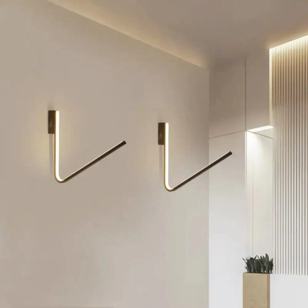 Modern gold v-shaped brass wall-mounted hooks with integrated warm white light and silica gel for corridor use