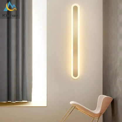 A sleek modern gold vertical led strip wall light with warm white glow and oval design for bedroom and living room decorbites led strip