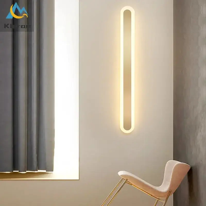 A sleek modern gold vertical led strip wall light with warm white glow and oval design for bedroom and living room decorbites led strip