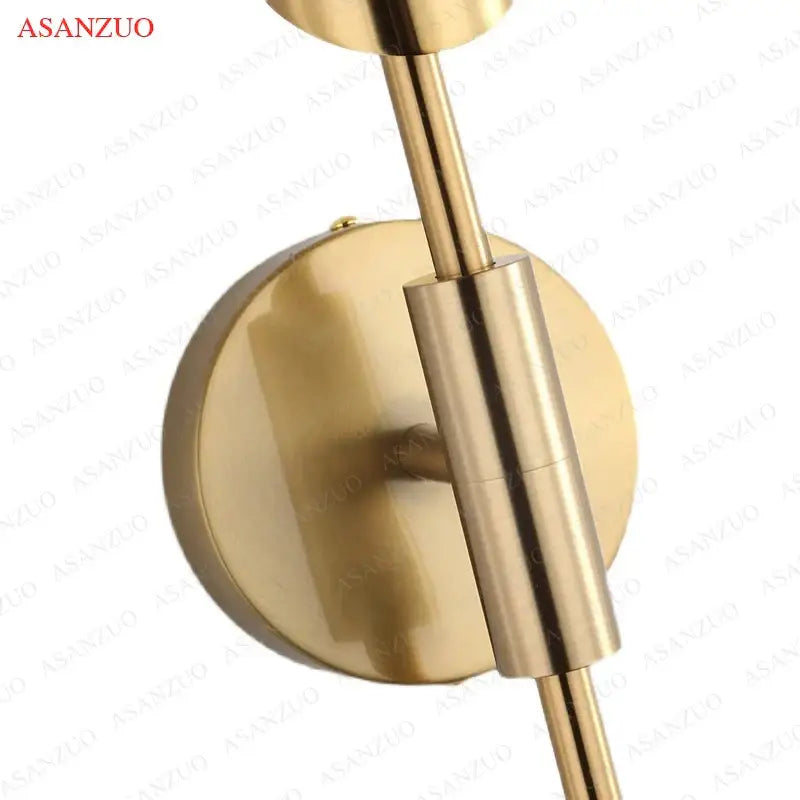 Brass-finished modern gold vertical led wall lamps with sleek cylindrical arm and circular mounting plate for living room