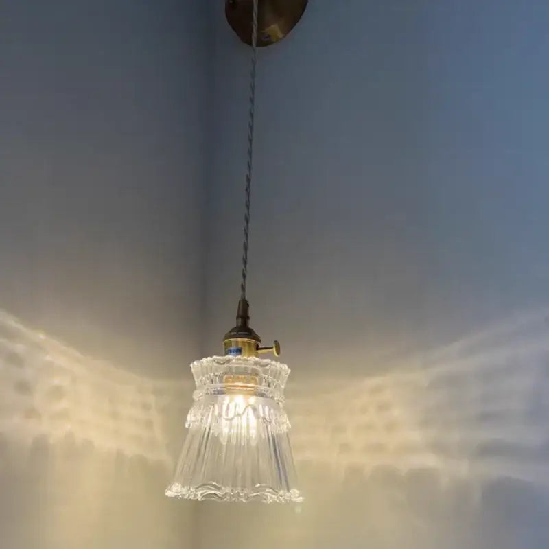 Modern gold wall lamp with clear glass shade featuring a faceted glass pendant and brass fixture by decorbites clear glass