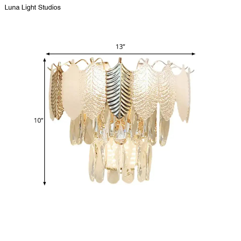 Modern gold wall light with gold-toned and silver leaf-shaped acrylic leaves and cascading crystal droplets e12 e14
