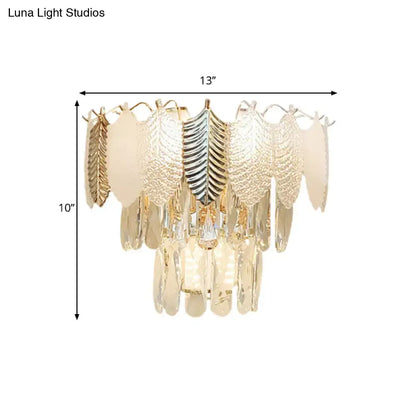 Modern gold wall light with gold-toned and silver leaf-shaped acrylic leaves and cascading crystal droplets e12 e14