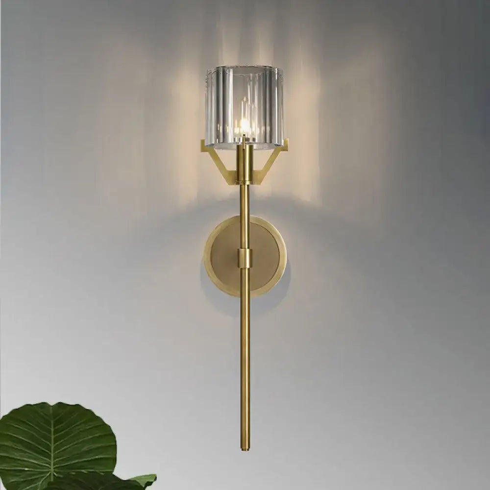Modern gold wall light with clear crystal block cylinder shade and sleek gold-toned metallic finish for bedroom use