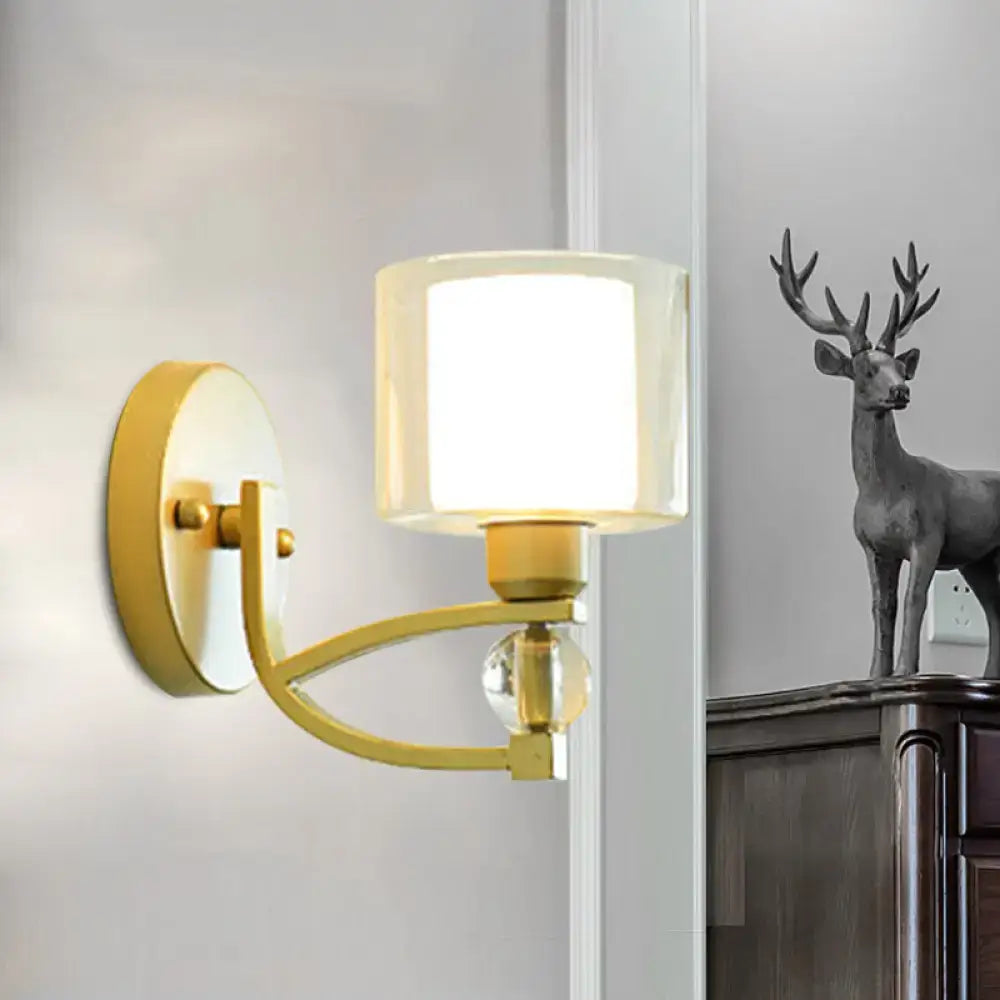 Modern gold wall mounted lamp with cylindrical frosted glass shade and crystal accent bead for indoor wall use