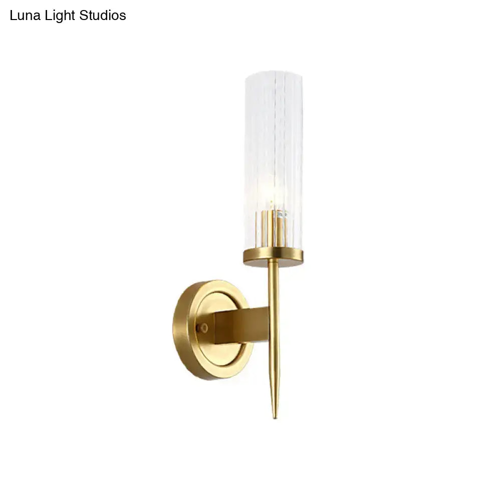 Modern gold wall sconce with clear ribbed glass cylinder and slender metallic stem compatible with 110v-120v led light