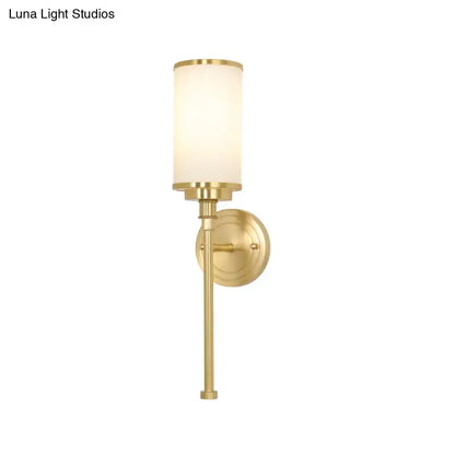 Modern gold wall sconce with a brushed brass finish and milky glass shade 12 inch fixture for living room lighting