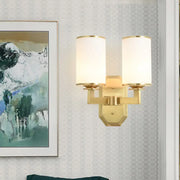 Modern gold wall sconce with opal glass cylindrical shades for bedroom lighting fixture