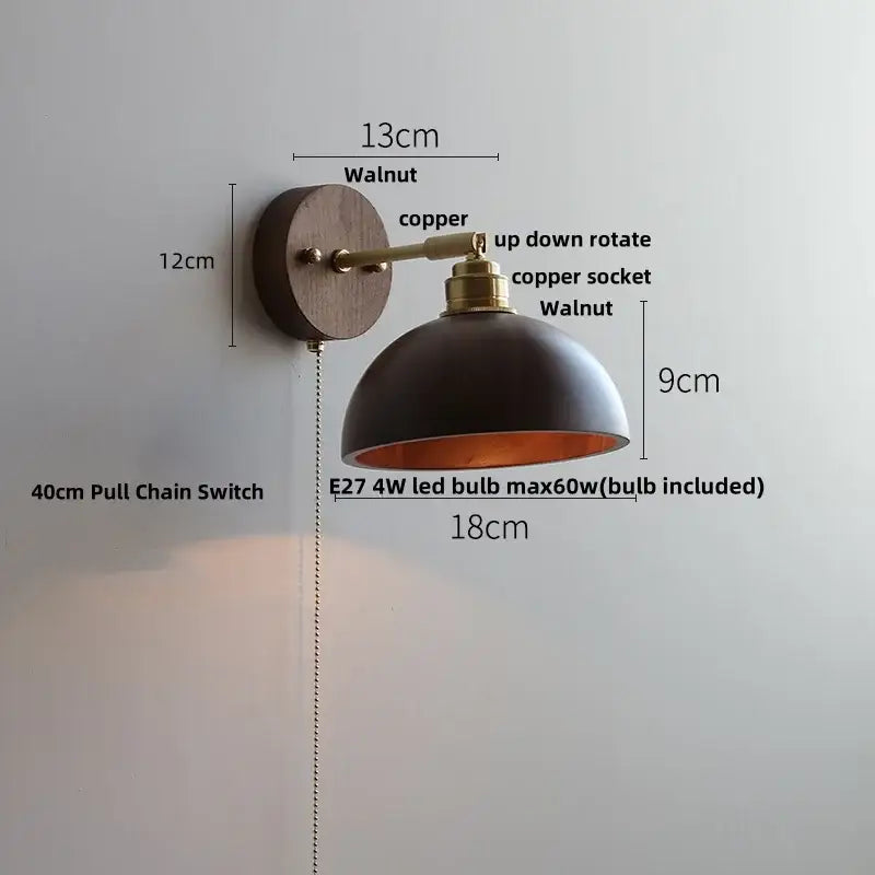 Modern gold walnut wall sconce with dark matte dome, copper accents, and pull chain switch for bedroom lighting