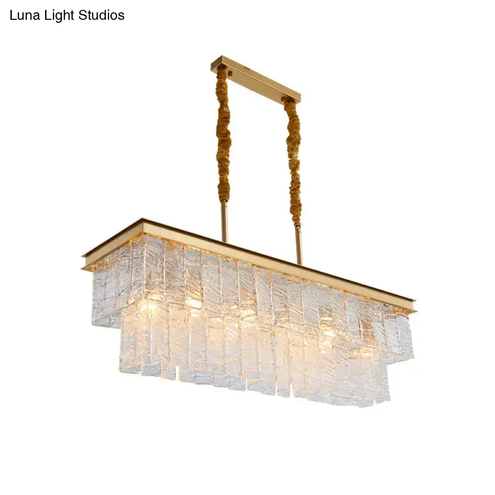 Modern gold rectangular pendant light with textured translucent glass panels and twisted rope cords for ceiling light use
