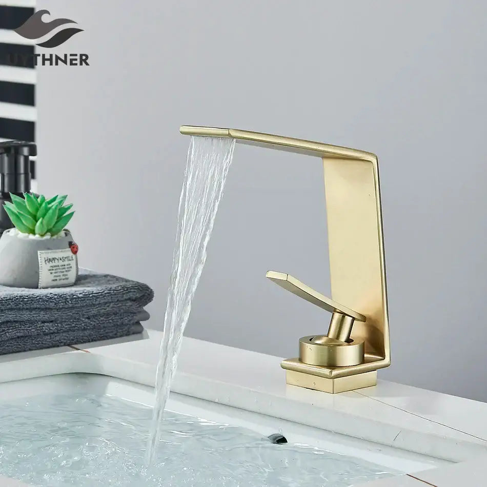 Modern gold waterfall basin faucet with brushed metal finish and sleek design by decorbites basin faucet for bathrooms