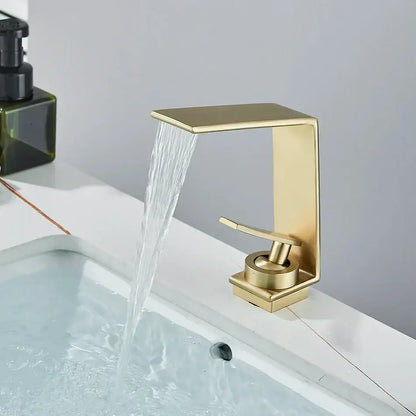 Modern gold waterfall basin faucet with brushed metal finish and sleek design by decorbites for bathroom use