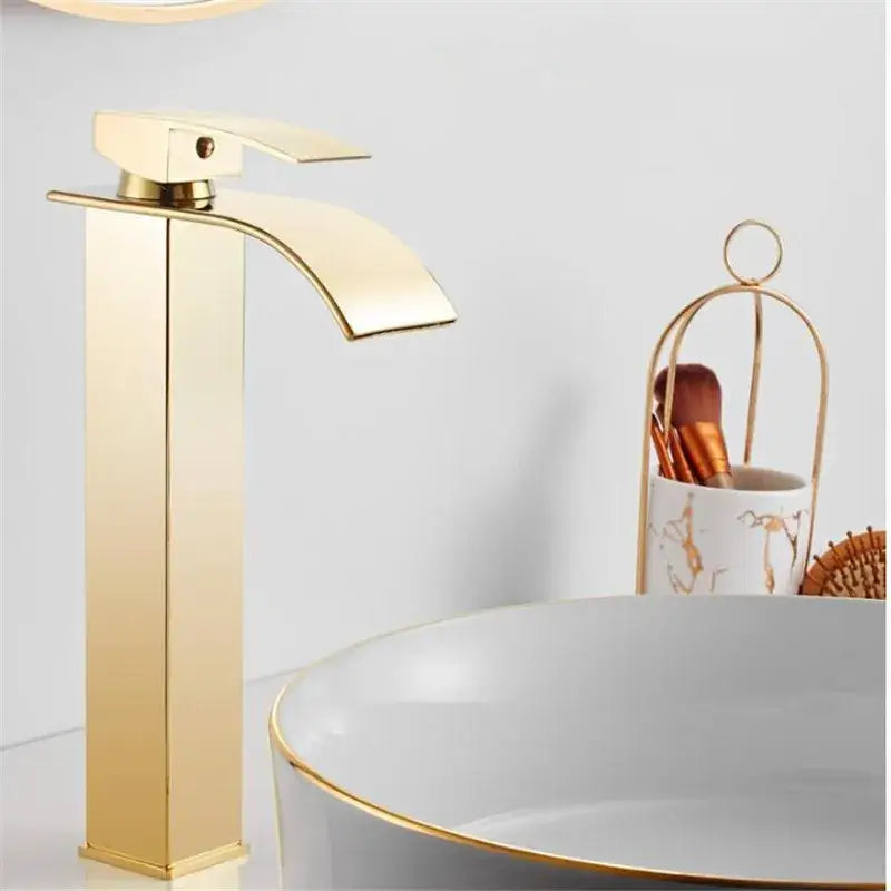 Modern gold waterfall basin faucet with a sleek rectangular spout and handle for stylish bathroom decorbites gold waterfall basin faucet