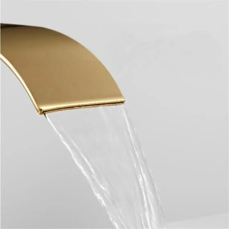 Modern gold waterfall basin faucet with sleek curved design and smooth metallic finish for bathroom use decorbites gold waterfall