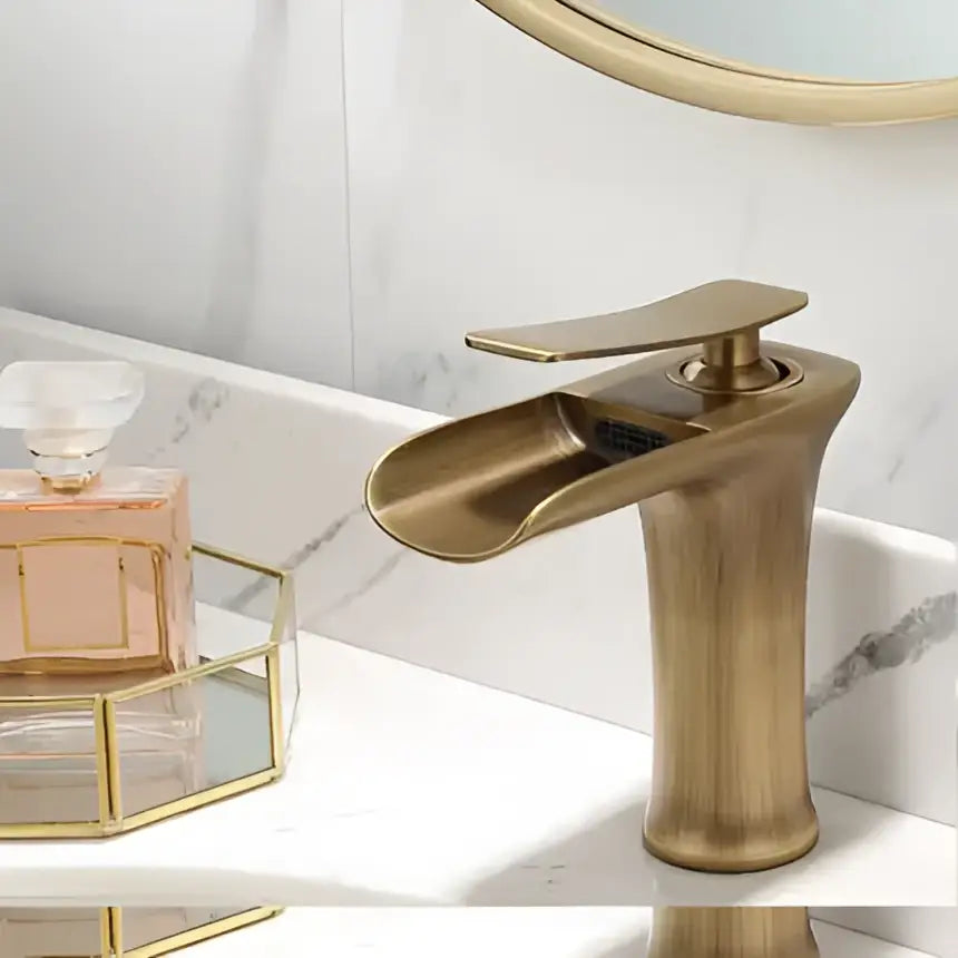 Modern gold waterfall basin faucet in brass with a sleek curved spout by decorbites gold for bathroom use