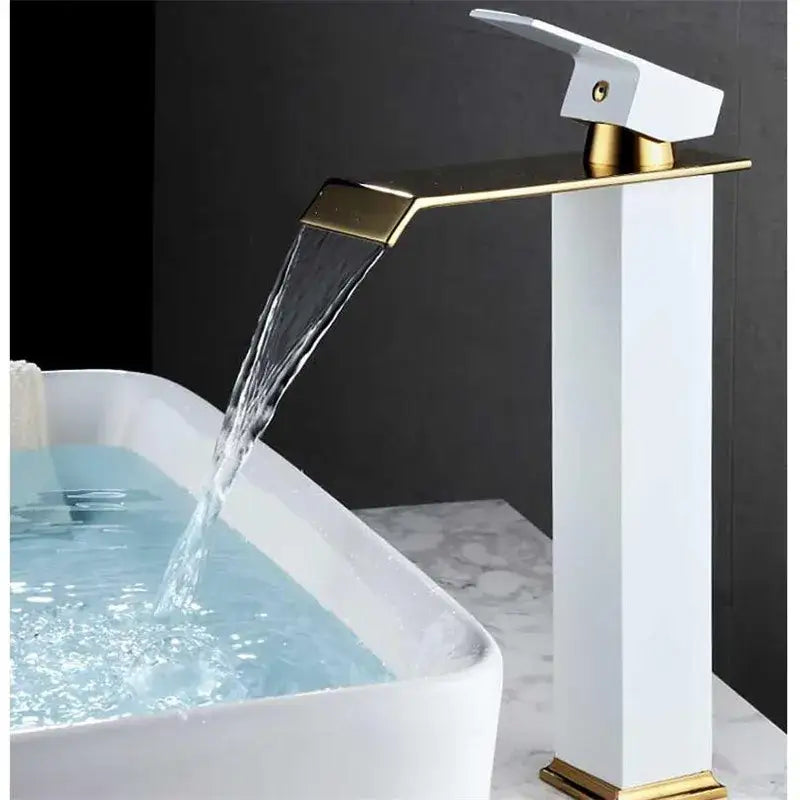 Modern gold waterfall basin faucet with sleek white ceramic body and polished gold accents cascades water elegantly