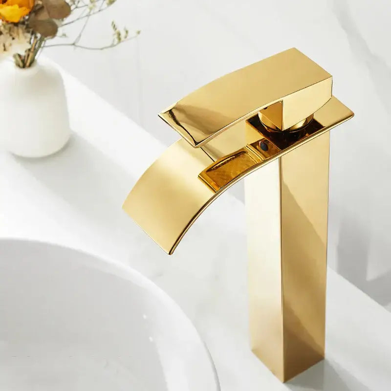 Modern gold waterfall basin faucet with a sleek rectangular spout and tall cylindrical base for bathroom decorbites gold waterfall