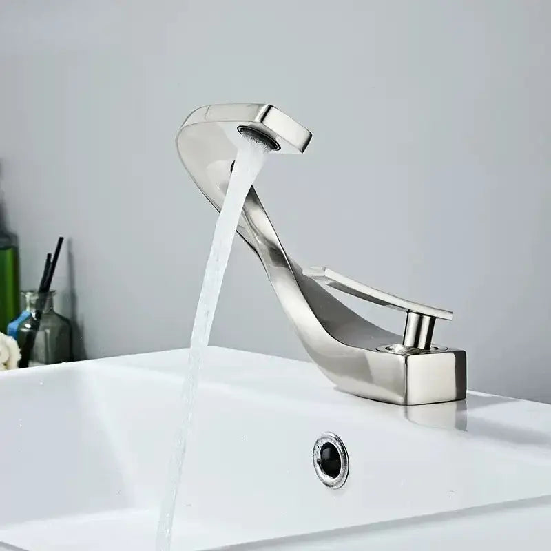 Modern chrome-finished decorbites brass basin faucet with sleek curved design for bathroom sink use