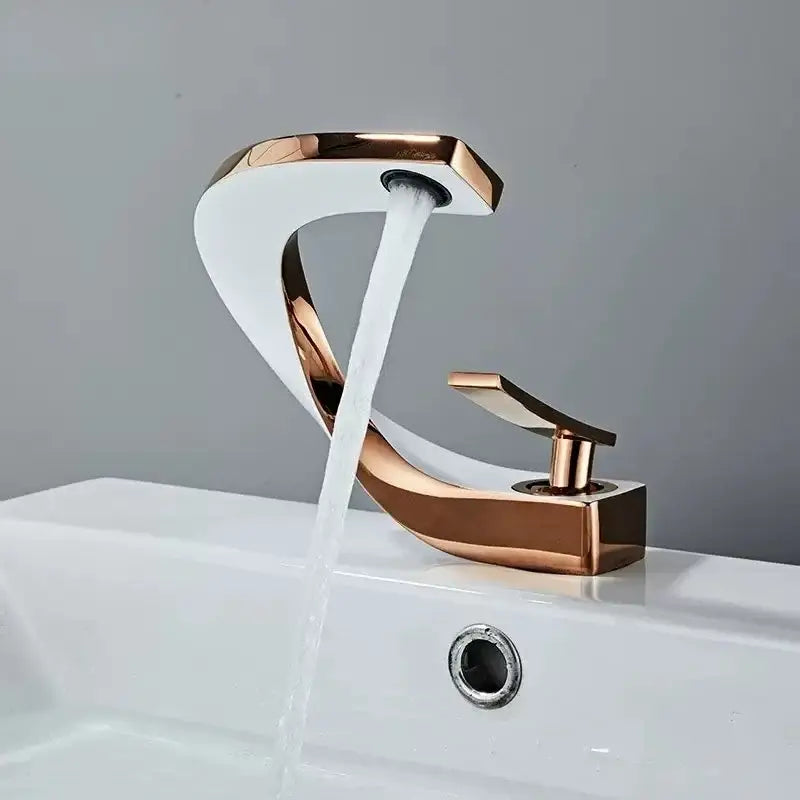A sleek rose gold brass basin faucet with modern curved design and flowing water for bathroom decorbites brass basin use