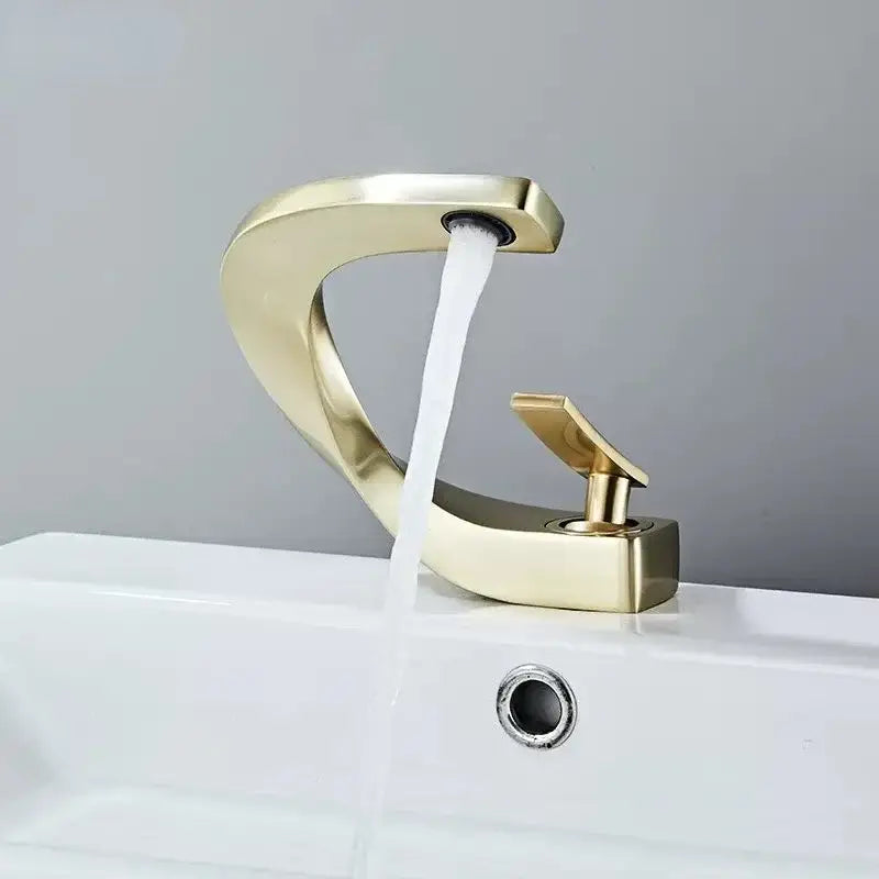 Modern gold waterfall brass basin faucet with sleek curved design and polished finish for bathroom sink decorbites brass basin