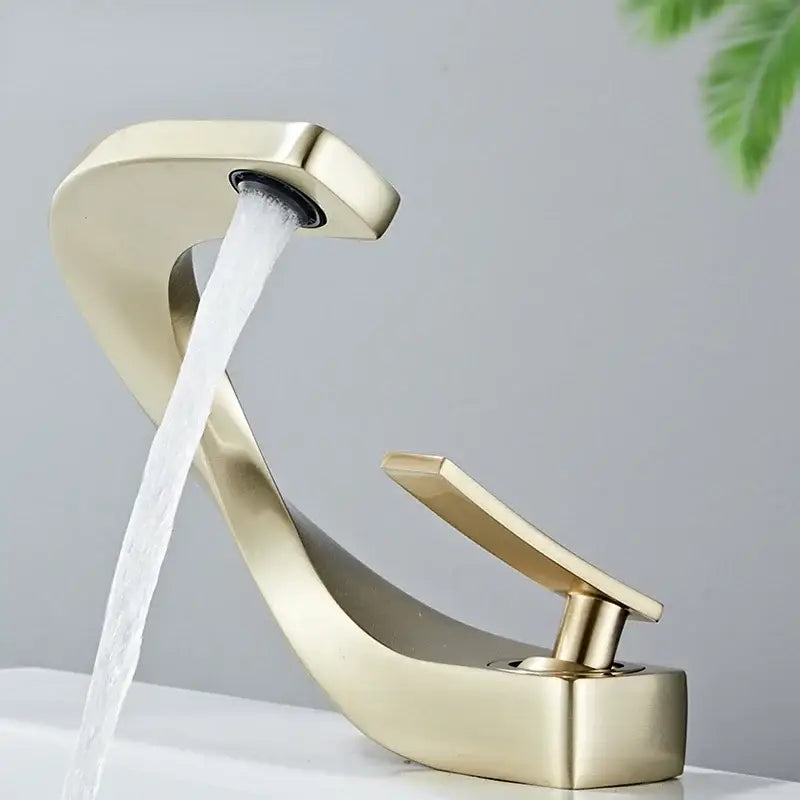 Modern gold-toned waterfall brass basin faucet with sleek curved design and single lever handle for bathroom decorbites brass basin