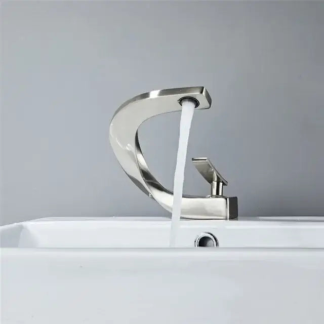 Modern gold waterfall mixer bathroom faucet with sleek curved design and single handle in brushed stainless steel