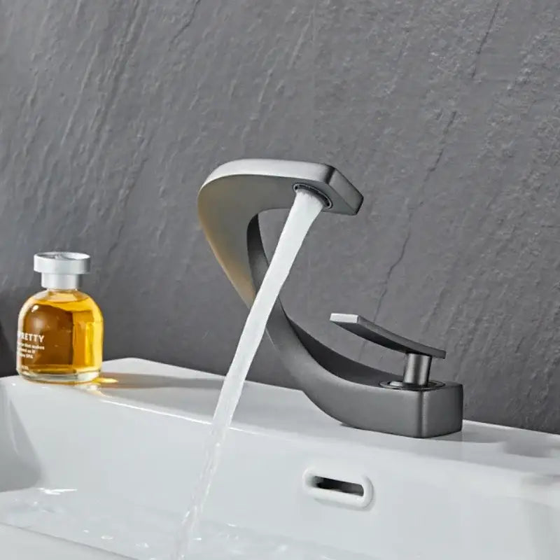 Modern matte black bathroom faucet with sleek curved design and flowing water for a waterfall mixer