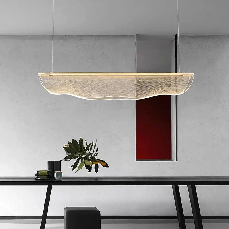 Modern gold wave mesh pendant light with translucent wave-patterned diffuser emitting warm ambient dining room lighting decorbites dining room