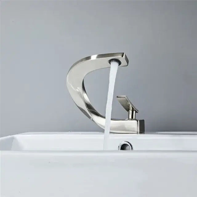 Modern brushed nickel bathroom basin faucet with sleek curved design and single handle for decorbites gold white decor