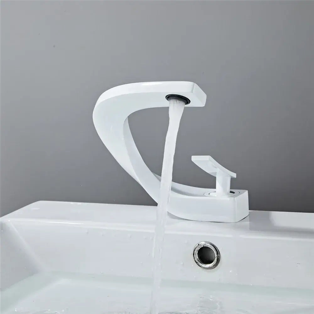 Modern gold white bathroom basin faucet with sleek curved white ceramic spout and single handle decorbites gold white design