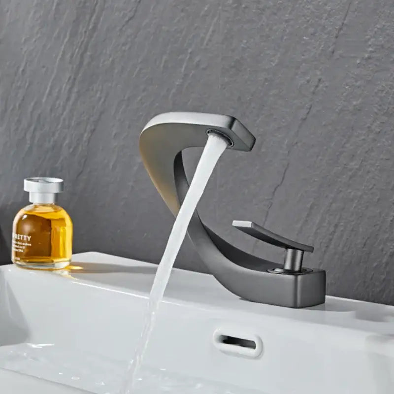 Modern matte black bathroom faucet with sleek curved spout and flowing water for decorbites gold white bathroom basin decor