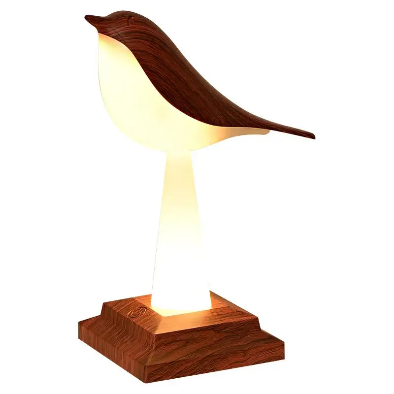 Warmly glowing bird table lamp with dark wood finish and sculpted form ideal for bedroom aromatherapy decorbites bird table