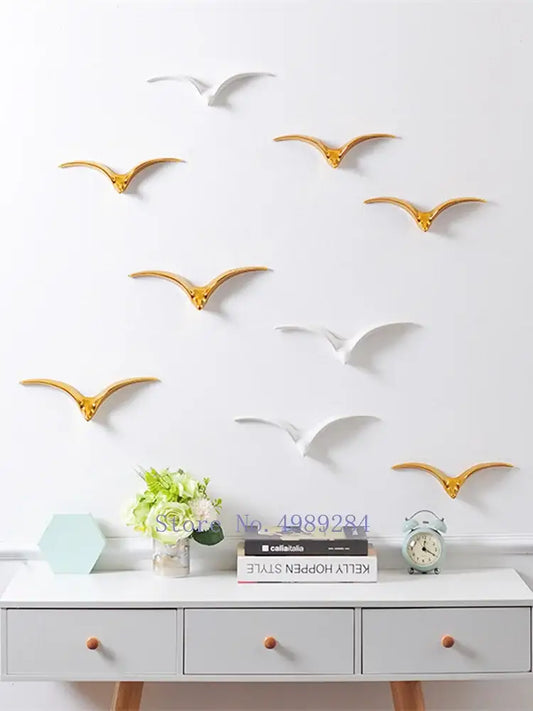 Modern gold and white ceramic pendant wall decor featuring metallic bird decals for living room wall decor